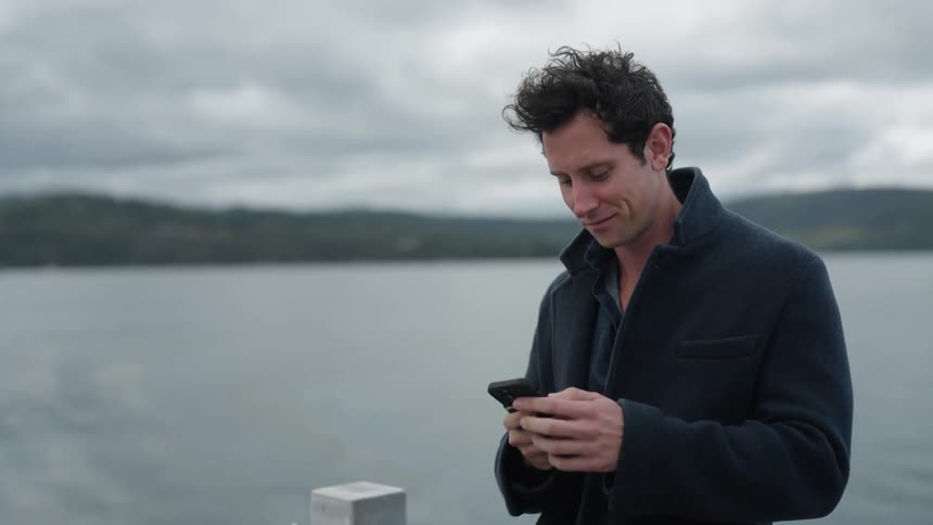 A man talks on his cell phone on the boat