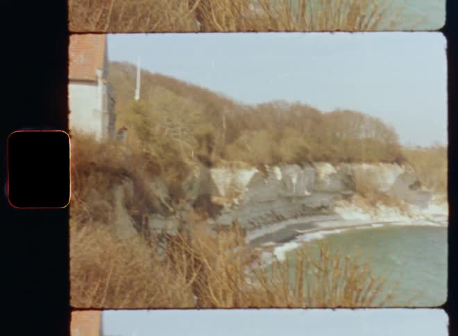 Building sits on edge of cliff overlooking ocean