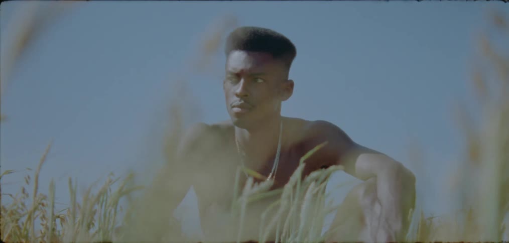 A man is sitting in the grass