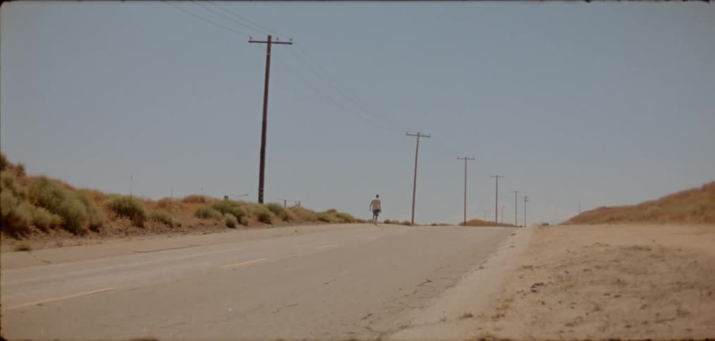 A man is walking down the road