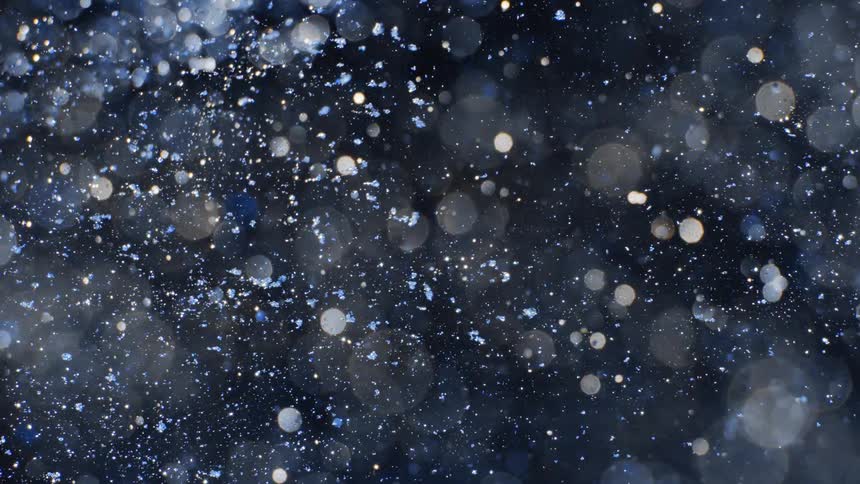 Glitter is tossed across a dark background