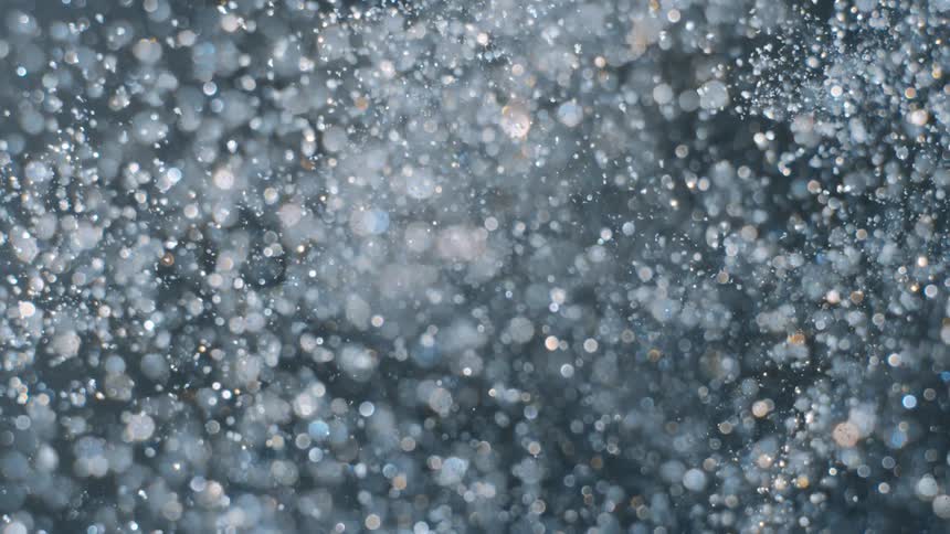 Glitter explodes against a dark background