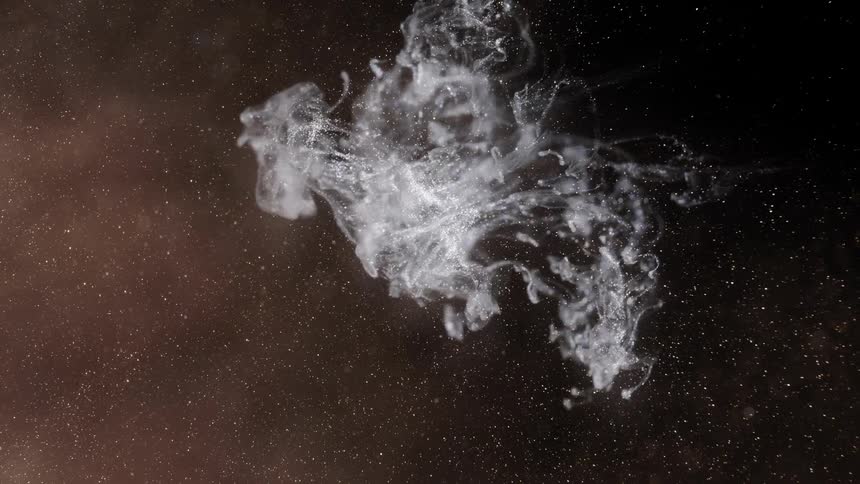 Pale cloud layer flows across glitter filled darkness