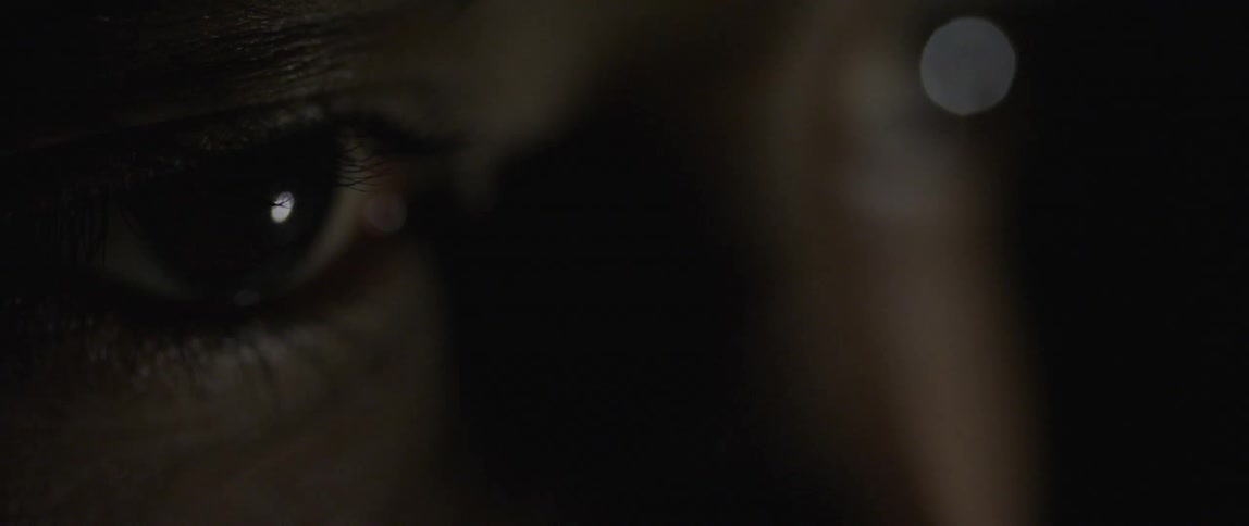 An eye looking at a video screen blinks
