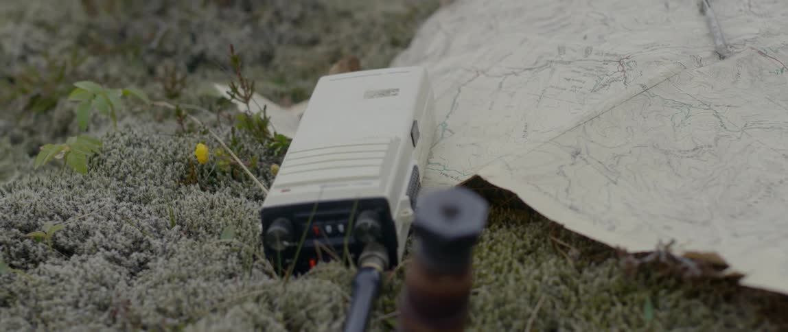 A close up view of a small electrical box on top of the grass