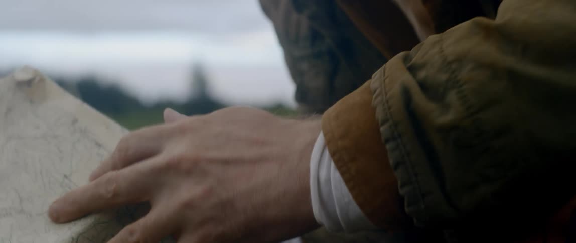 A white man opens up a map