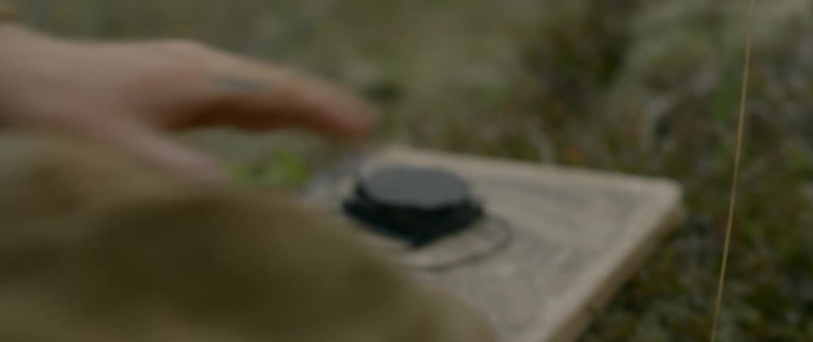 A man taking off a necklace