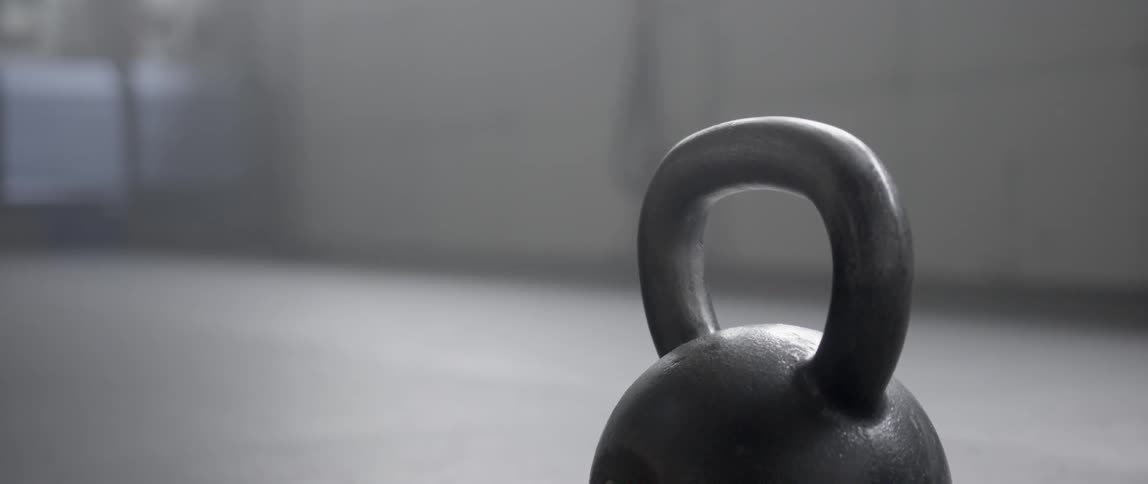 A kettle bell sits on the floor