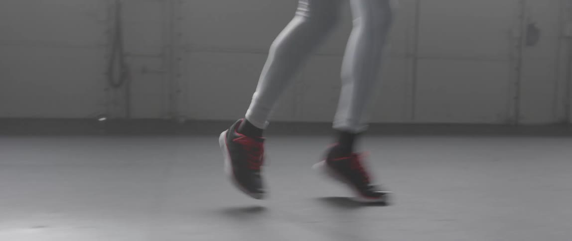 A man is running backwards twirling