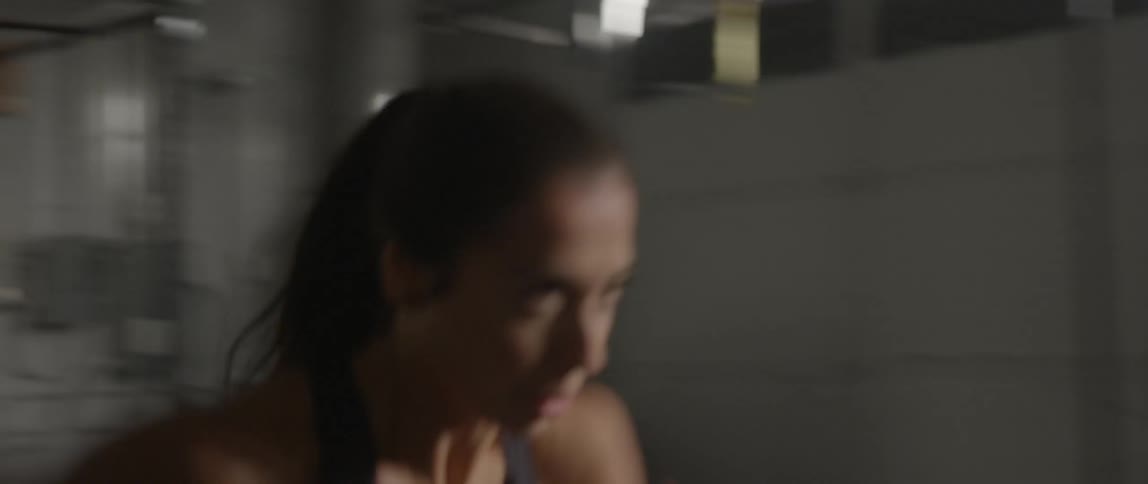 A woman doing sprints in a gym