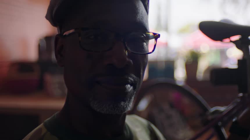 Old man wearing glasses looking at the camera