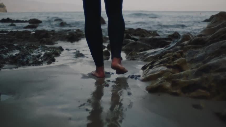 A person walks towards the ocean