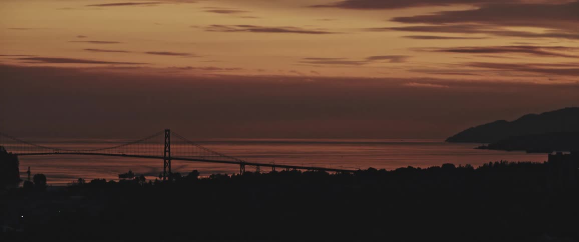 A bridge at a coast at sunset