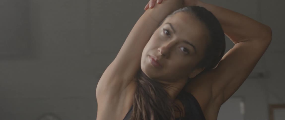 A woman is stretching her arms