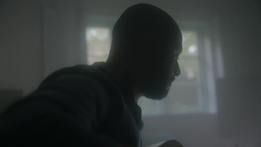 A bald man playing a guitar