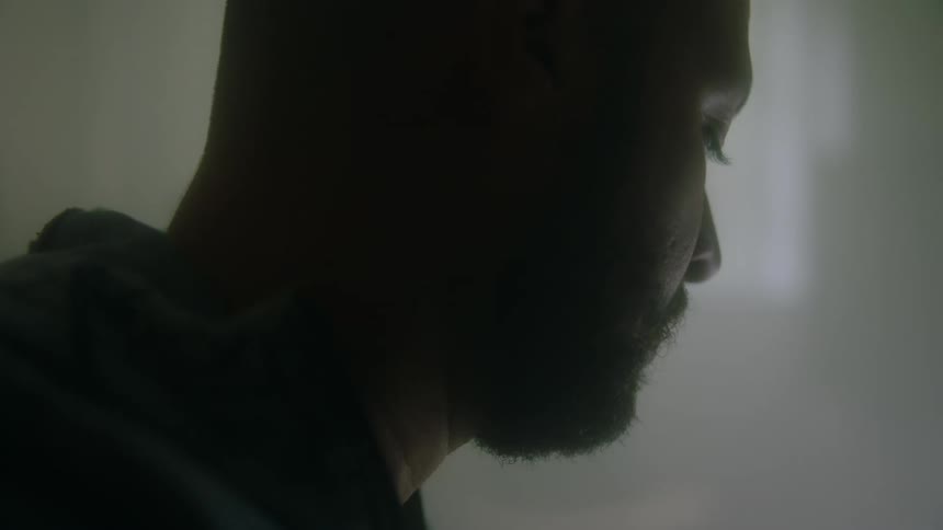 A man moves his head up and down to music