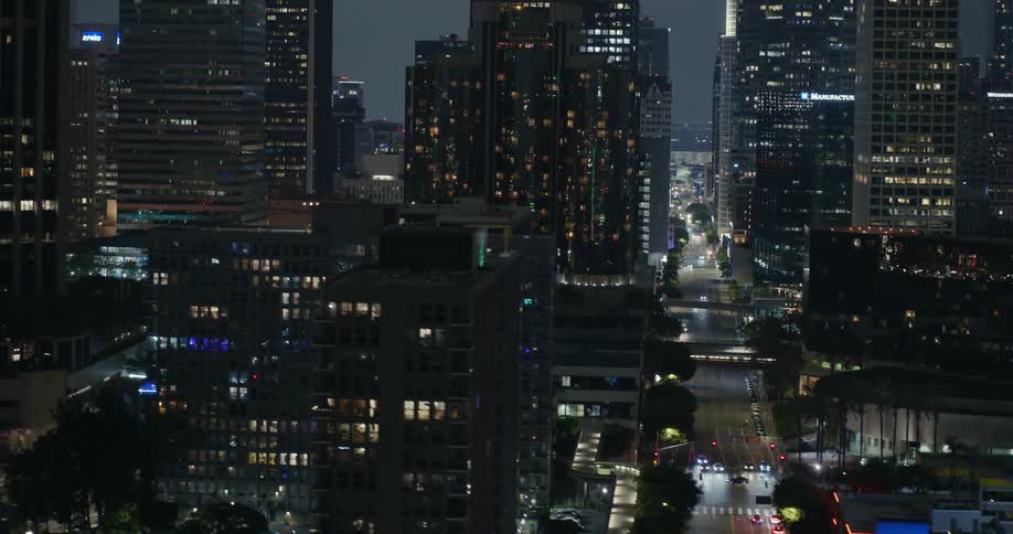 Series of pedestrian bridges cross downtown streets at night