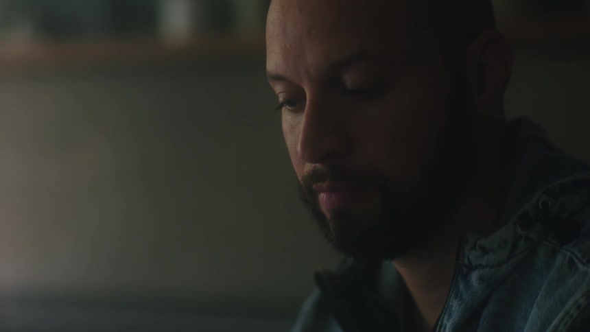 A close up view of a man sitting indoors