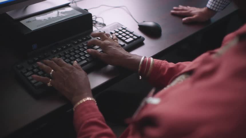A woman is typing on the keyboard