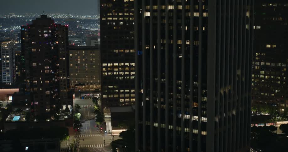 Skyscrapers loom over an intersection in a metropolis at night
