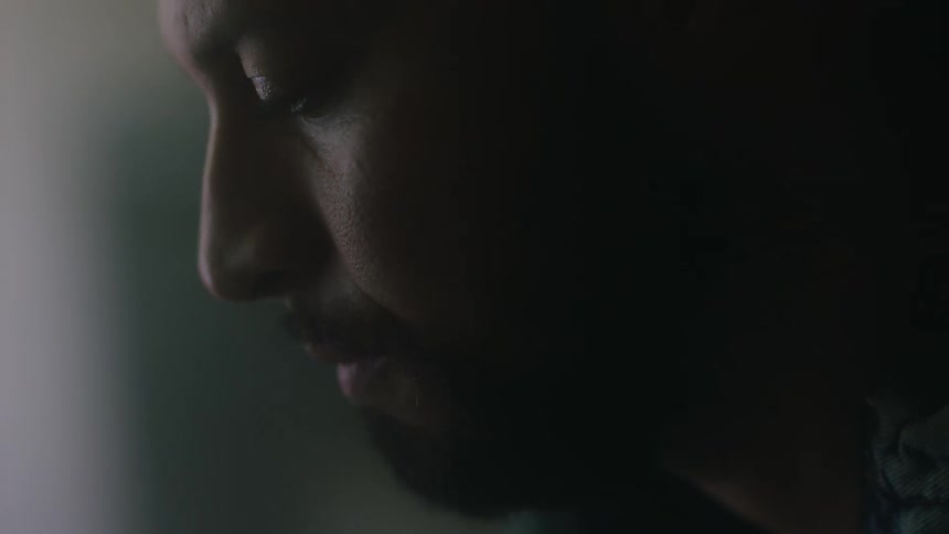 A bearded man with a pensive melancholic expression