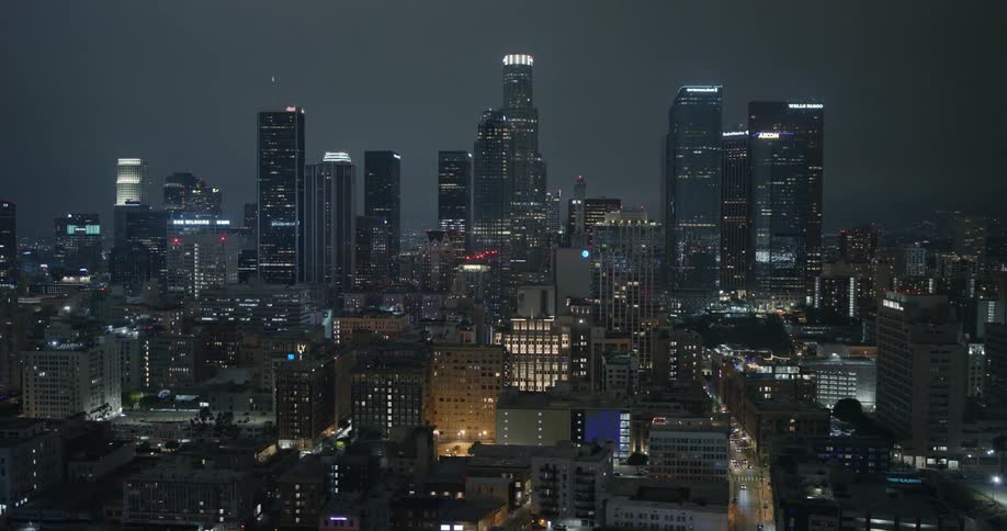 Skyscrapers loom over a metropolis at night