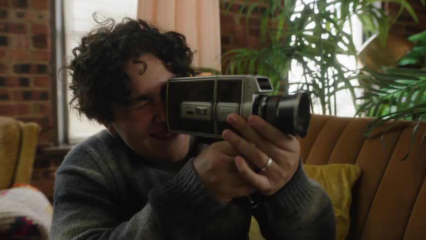 A man is filming with his camera