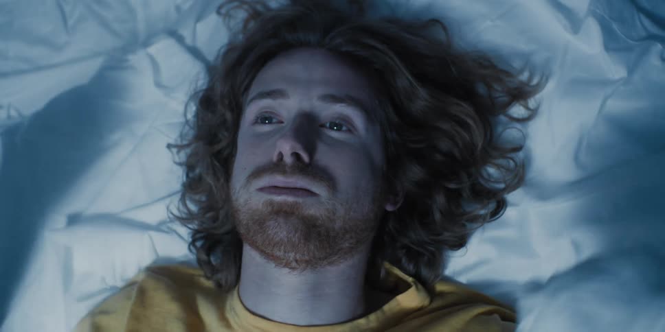 Man lying on a bed determined to fight