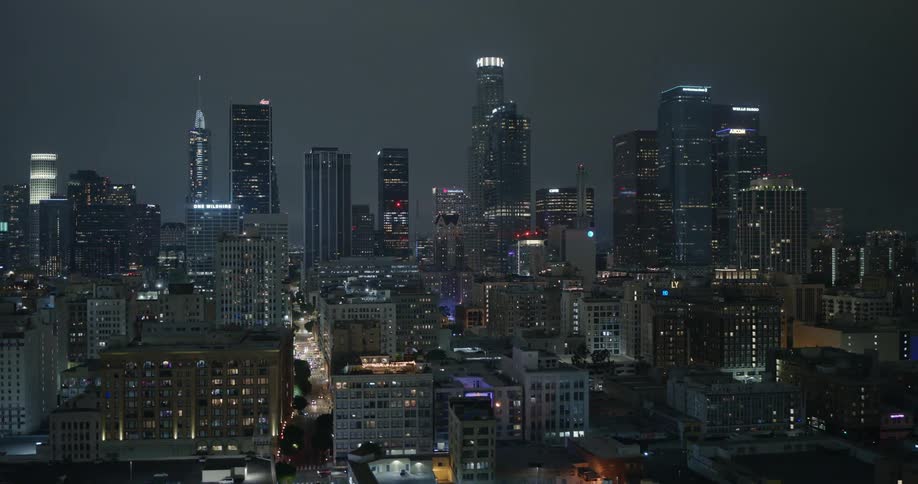 Skyscrapers loom over a metropolis at night
