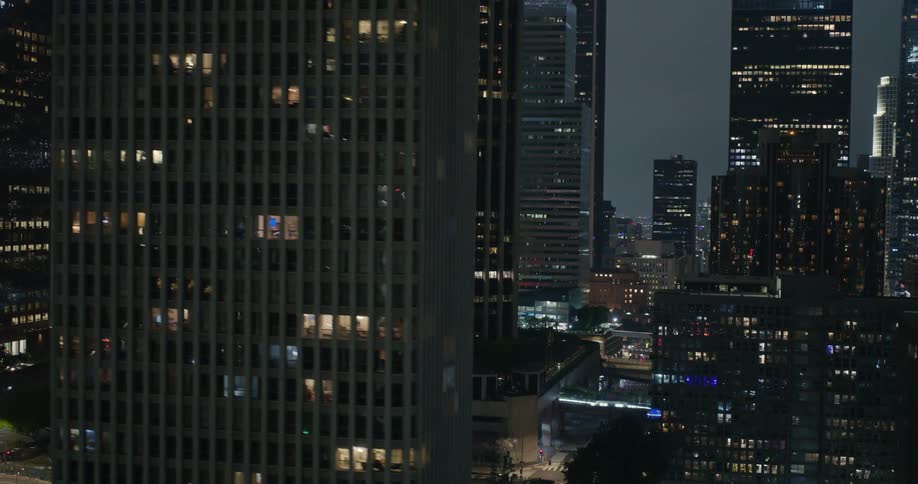 An aerial view of high rise buildings in a downtown area at night
