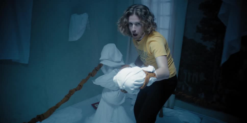 Man fighting in a ring inside the house wearing gloves made from white sheets