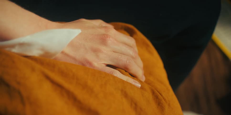 A persons hand squeezing blankets