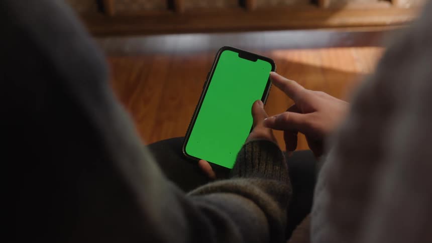 Man and woman hands touching and scrolling the screen of a smartphone