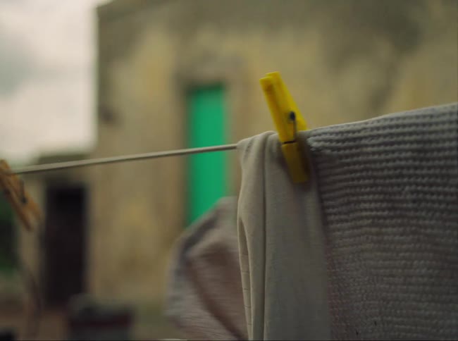 Person picking up clothes from the clothesline