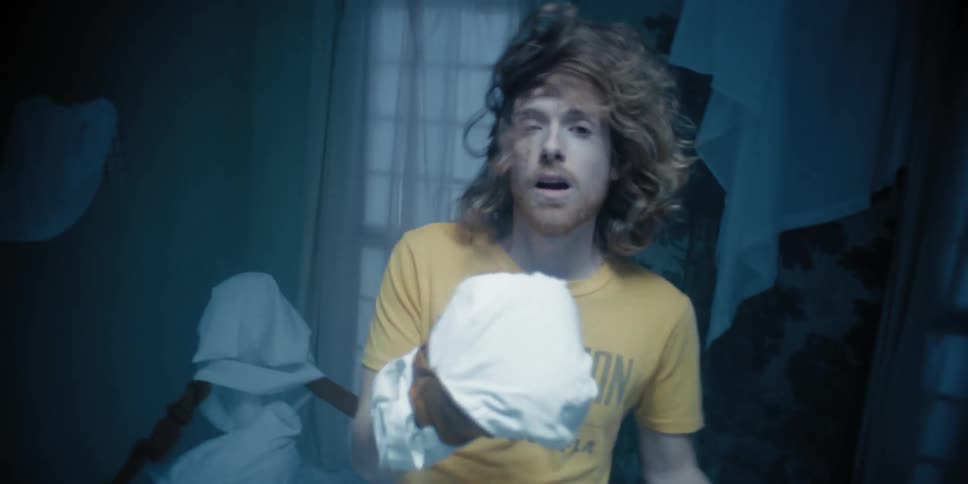 A man wearing a yellow shirt getting punch in the face and moving around erratically
