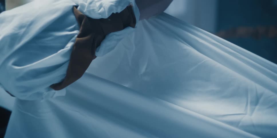 A man has a sheet wrapped around his hand