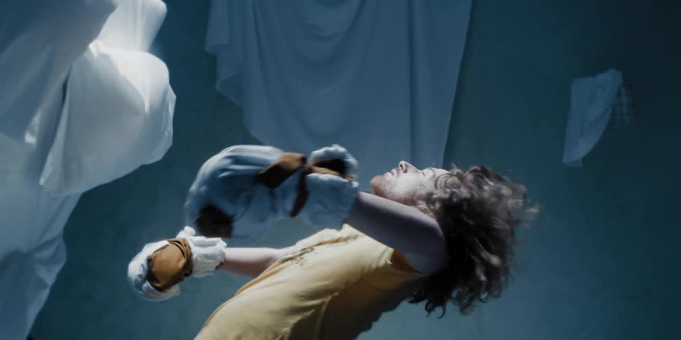 Man falling after being punched from a bed