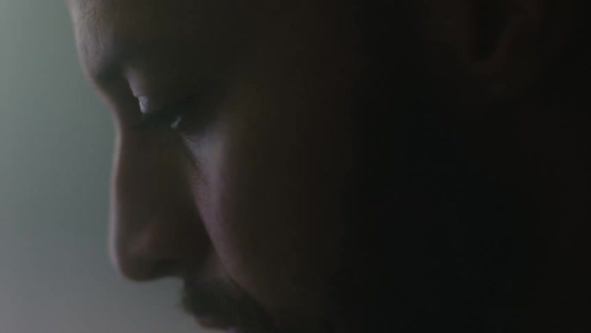 A man looks down in thought