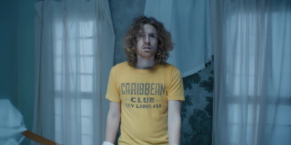 Confused man in a room with boxing gloves