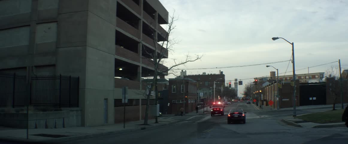 An emergency vehicle is parked in front of a building