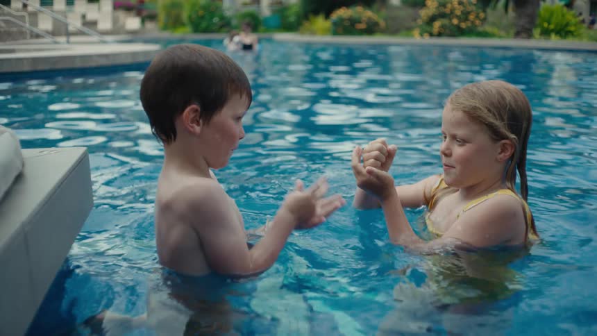 Two children playing in a swimming pool