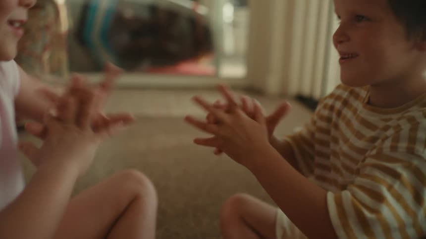 Two kids playing rock paper scissors