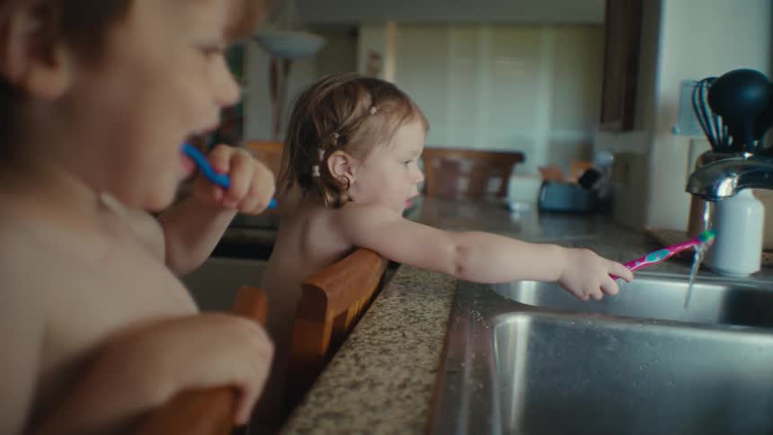 Two kids brushing their teeth