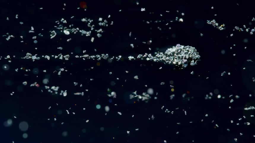 Meteorite flying through space leaving a trail of debris