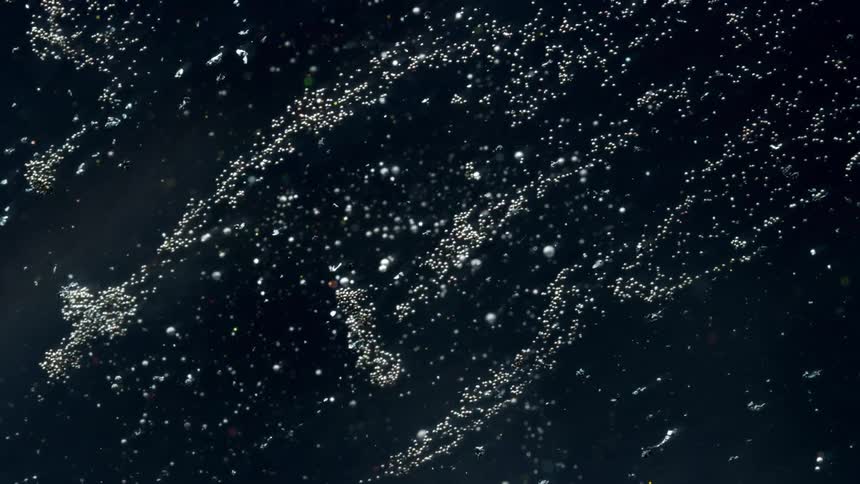 The view is of a meteorite rain in the outer space at night time