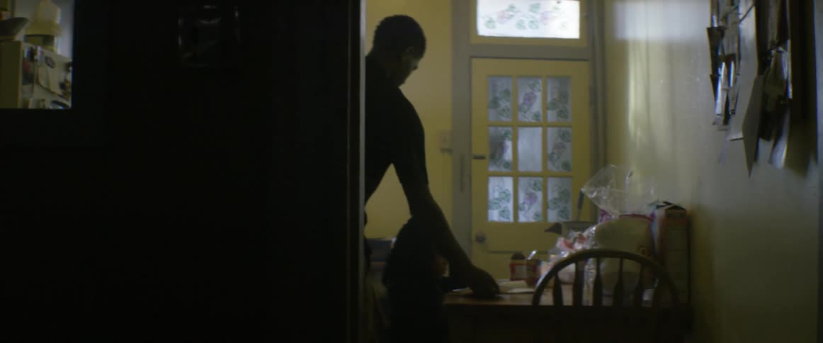 A man is setting a table inside