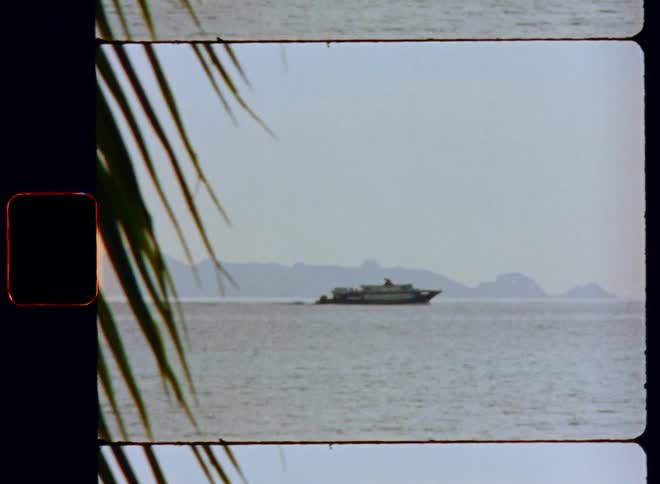 Cruise ship moves through water between opposing shores on foggy day