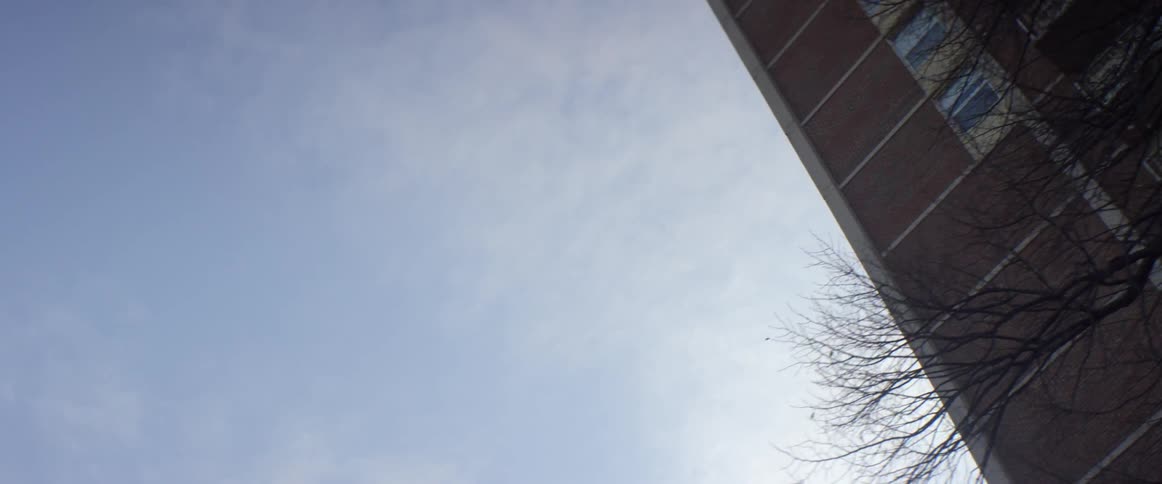 A building lines a cloudy sky