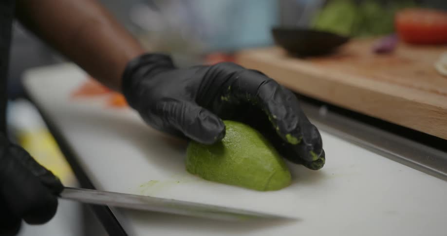 Close up view of a person cutting an avocado