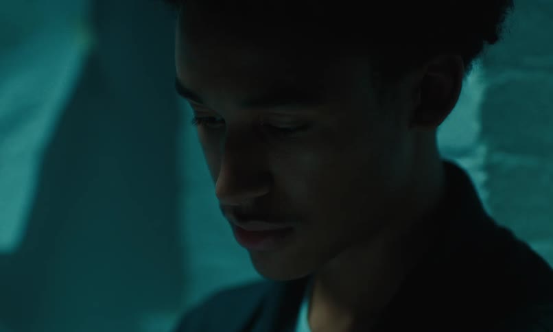 Portrait of a male looking down and standing indoors